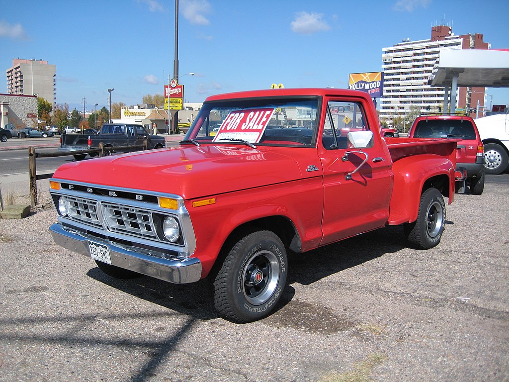 Photo of a red Dentside Ford truck with a For Sale sign in the window